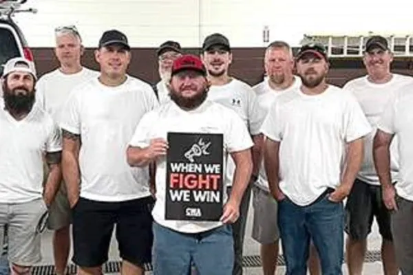Frontier workers holding a sign