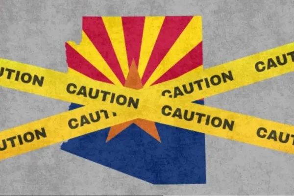 Arizona flag with caution tapes wrapped around it