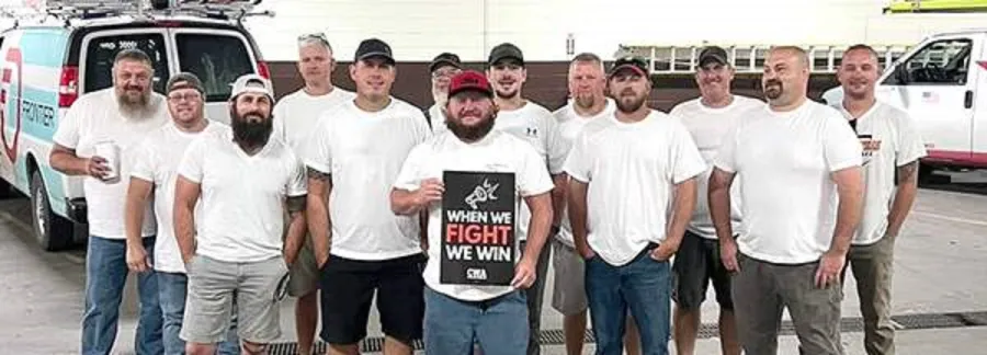 Frontier workers holding a sign