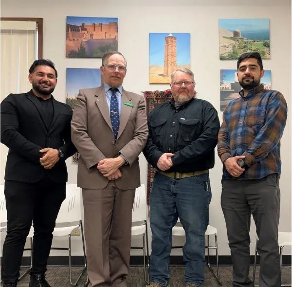 CWA Local 7603 President Jeremiah Clever standing with members of the Afghan Cultural Center