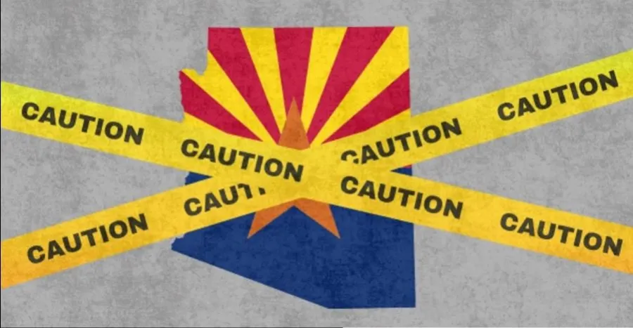 Arizona flag with caution tapes wrapped around it